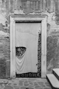 a hidden wooden door in Venetian street