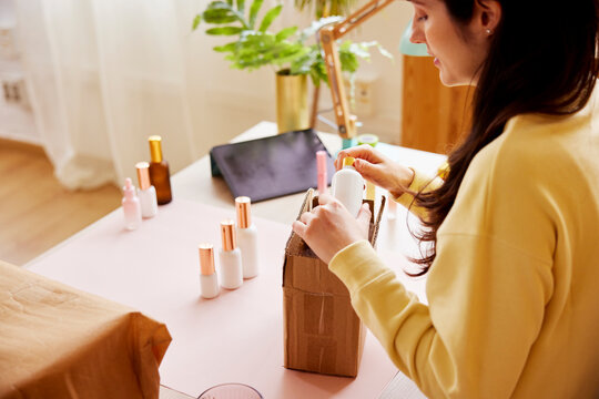 Female entrepreneur packing cosmetic products