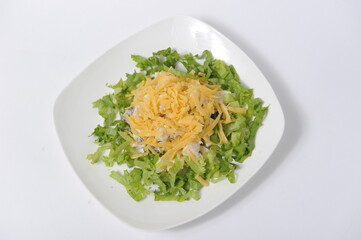 Salad of different types of greens and cheese on a serving plate.