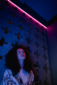 Cinematic creative portrait of a woman in neon light