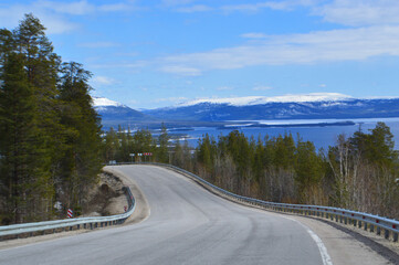 Landscape with road and snow-covered Mountain in May 