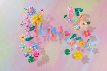 Happy lettering with colors flowers from plasticine clay