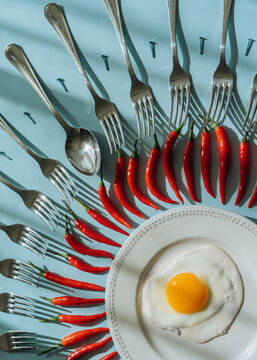 Conceptual still life with fried egg and hot paper.