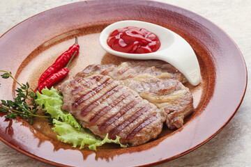Grilled pork neck steak with ketchup