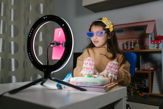 Preteen blogger recoding video on smartphone