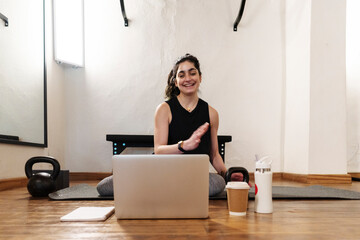 Fitness instructor conducting online lesson in gym