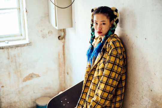 An asian young woman in corridor of an old building