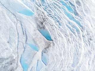 Natural travertine pools blue water in Pamukkale Turkey aerial top view