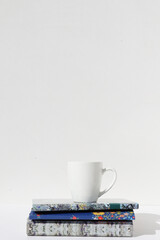 books and notepad on a white background