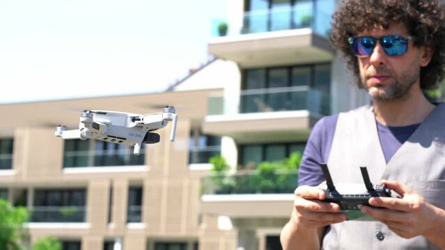 Man use the drone for surveys and measurements to create a 3d virtual reality model of the building - drone in construction works -  new technology on construction sites - Real estate video and photo