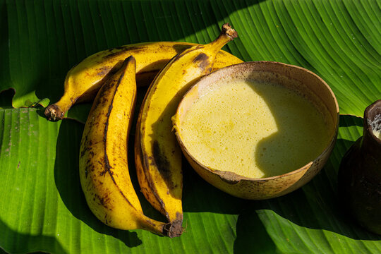 Ripe Plantain On Banana Leaves Next To Beverage 