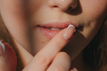 Anonymous woman applying lips scrub