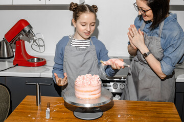 the family is happy that they cooked a cake together in the kitchen