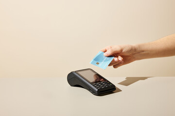 Anonymous person using credit card and payment terminal