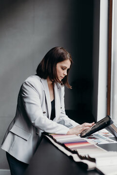 Businesswoman working on design project near window