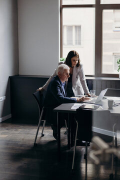 Businesspeople reading data on netbook