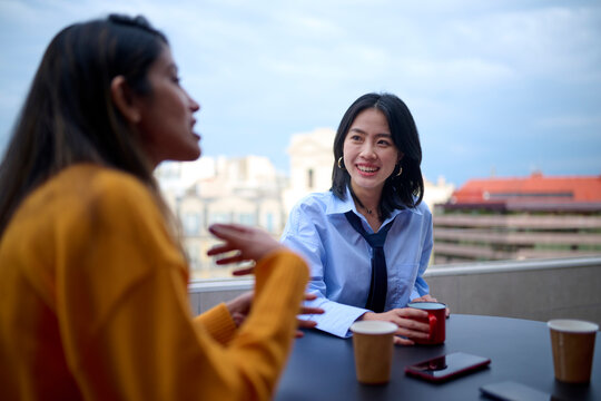 Asian woman listening to colleague