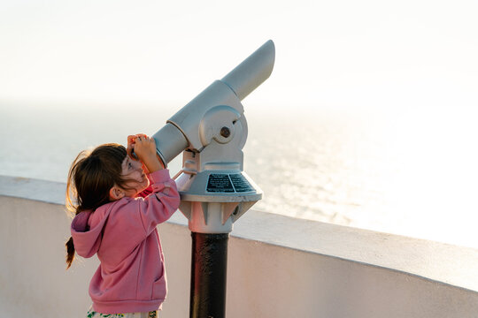Little girl looking with monocular 