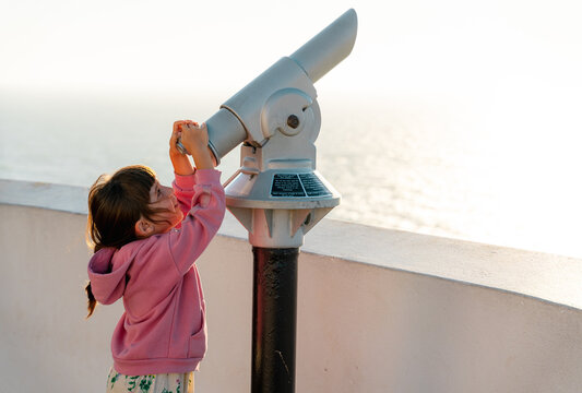 Little girl looking with monocular 