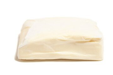 Tasty butter in paper packaging isolated on white