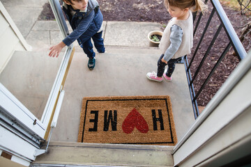 Children walking in and out of front door 