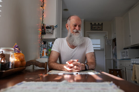 Man sitting at kitchen table.