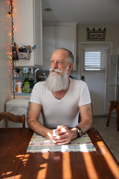 Man sitting at kitchen table.