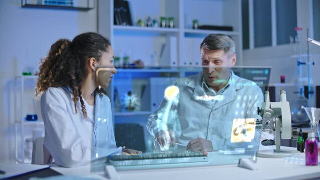 Male and female doctors discussing medical test results in modern laboratory