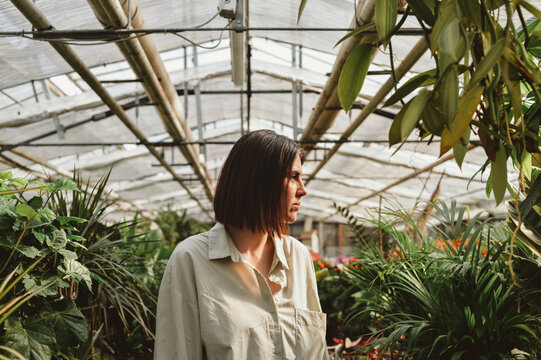 Curious gardener in greenhouse