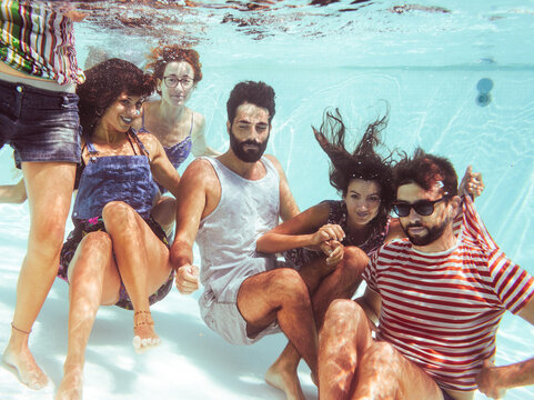 Funny underwater portrait of group of friends