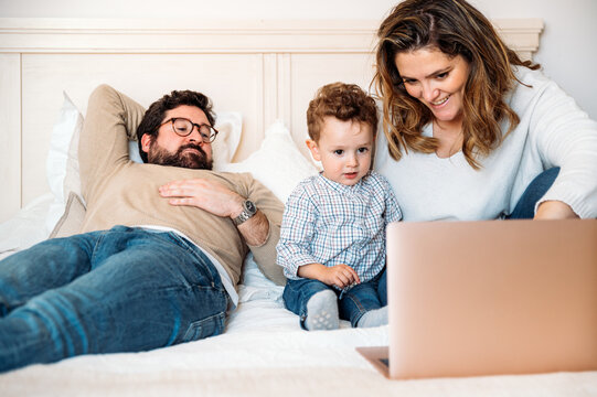 Family watching cartoon with child on laptop