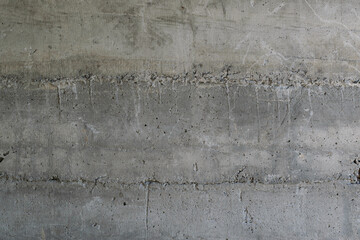 Texture of reinforced concrete laid in layers. Surface of old and dirty reinforced concrete with traces of formwork.