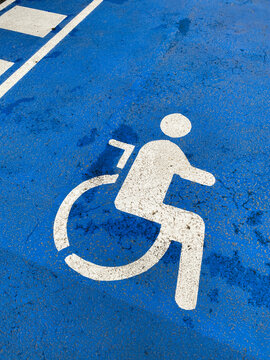 symbol of person in wheelchair on blue tarmac