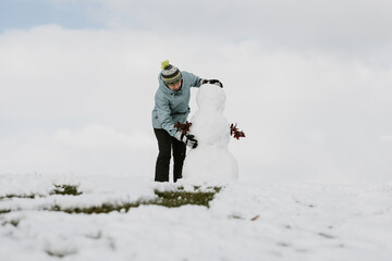 Woman make a snowman