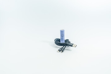 Black charging cable and battery 18650 with smile isolated