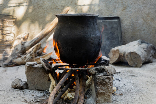 Black clay pot on a traditional stove with high fire 
