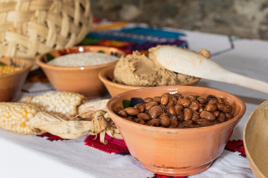 Table with clay bowls and Mexican ingredients inside 