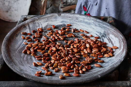 Cocoa beans roasting on a clay comal in Teotitlan Oaxaca