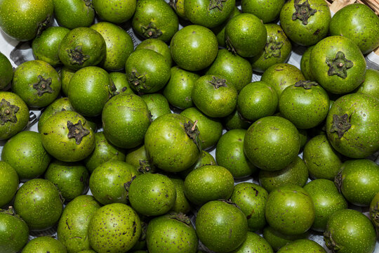 fruit called black sapote stacked on top of each other