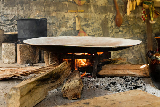 Firewood lit under a comal in a Mexican Kitchen