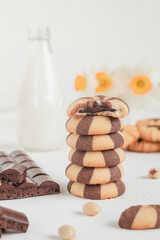 Striped cookies with chocolate filling. Sweet breakfast with cookies and milk.