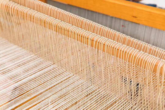 closeup to a wooden loom to make wool rugs 