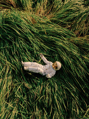Astronaut lying on grass in nature