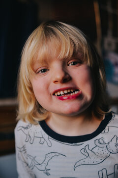 Smiling portrait of 5 years old kid with lipstick