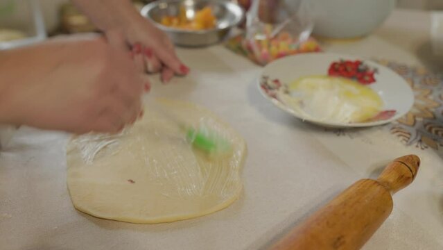 woman buttering the dough close up home made food