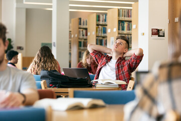 Student Taking A Moment To Think While Working