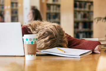 Female College Student Falls Asleep In Library