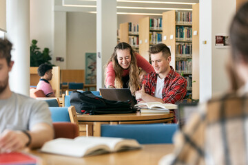 Cheerful College Friends Working Together