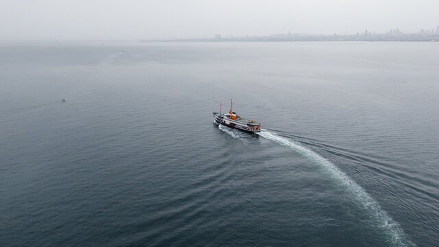 ferry in the sea shot with drone, long tail trace