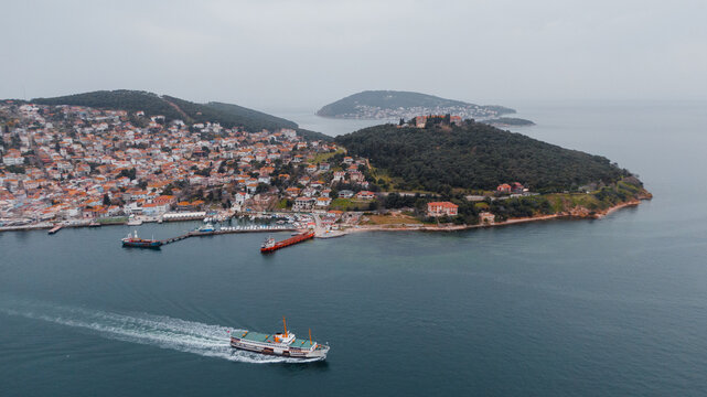 aerial photo of a ferry passing by Prince Islands in Turkey